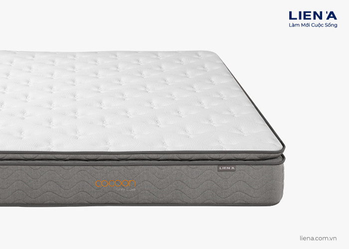 Nệm lò xo túi COCOON GREY LUXE kết hợp cao su và than hoạt tính, tăng cường kháng khuẩn và bảo vệ hô hấp, một sản phẩm chăm sóc giấc ngủ được đề xuất bởi tic.edu.vn.